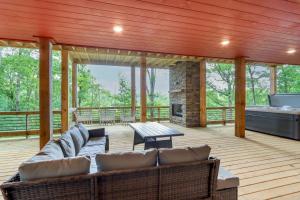 a living room with a couch and a fireplace at Mid-Century Modern Home with Hot Tub and Mtn Views! in Ellijay