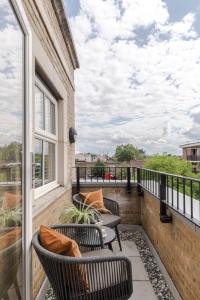 a balcony with two chairs and a table at Southwark Serviced Apartments I Your Apartment in London
