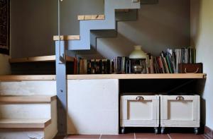 a stair case with a book shelf and a staircase at Chorto Garden Home in Chorto