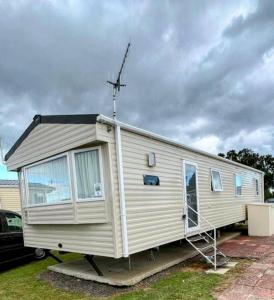 a mobile home is parked in a driveway at 8 berth caravan,pet friendly. in Merston