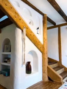 a room with a staircase in a house at Inside, The Village- Bibliotheca in Tunari