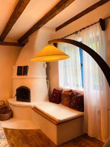 a room with a bench with a window and a lamp at Inside, The Village- Bibliotheca in Tunari +44 photos
