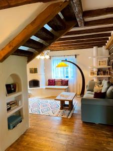 a living room with a couch and a table at Inside, The Village- Bibliotheca in Tunari