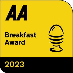a sign that reads breakfast award with a microphone at Lion House Bed & Breakfast with Restaurant in Combe Martin