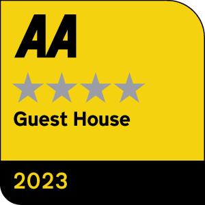 a sign for a guest house with four stars at Lion House Bed & Breakfast with Restaurant in Combe Martin