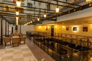 a large room with a table and chairs and lights at Afyon MCG Marble Hotel in Afyon