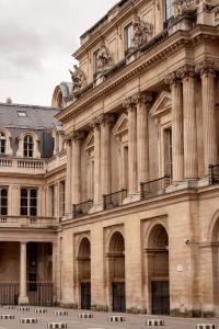 a large building with columns on the side of it at Balyam Suites Montorgueil - Sentier in Paris