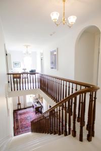 a winding staircase in a home with a chandelier at Woodbourne Inn in Niagara-on-the-Lake