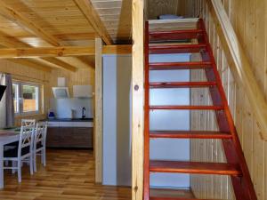 a ladder leading up to a kitchen in a tiny house at Holiday house in Pobierowo for 4 people near the sea in Pobierowo