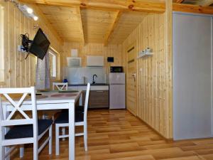 a kitchen and dining room with a table and chairs at Holiday house in Pobierowo for 4 people near the sea in Pobierowo