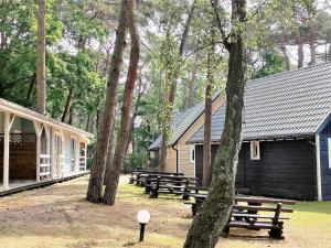 a group of benches in front of some buildings at Holiday house in Pobierowo for 5 people near the sea in Pobierowo