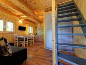 a living room with a staircase in a tiny house at Holiday house in Pobierowo for 5 people near the sea in Pobierowo
