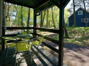 a porch with a table and chairs and a barn at Holiday house in Pobierowo for 5 people near the sea in Pobierowo