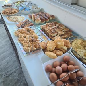a buffet table with various types of pastries and eggs at Sunrise Apart-Hotel in Ulcinj