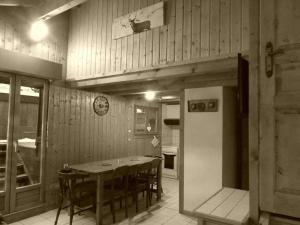 a kitchen with a table and chairs and a refrigerator at Demi-Chalet Le Bief --Prox pistes in Les Carroz d'Araches