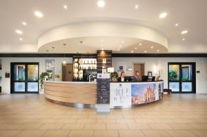 a lobby with a bar in the middle of a building at iH Hotels Milano Gioia in Milan