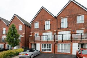 an apartment building with a car parked in front of it at Stunning 5-Bed House in Ashford in Ashford