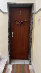 a brown door with a wreath on it at Charming apartment in Lisbon in Lisbon