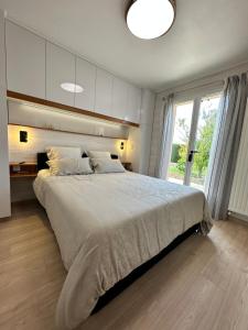 a bedroom with a large bed and a large window at Le mas des anges in Soussans +55 photos