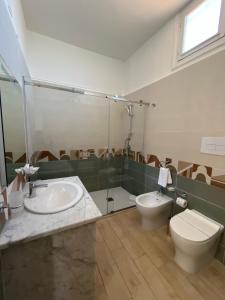a bathroom with a toilet and a sink at 38 Aira Hotels in Palermo +45 photos