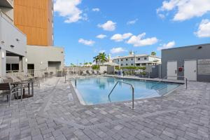 a large swimming pool in a courtyard with a building at TownePlace Suites by Marriott Cape Canaveral Cocoa Beach in Cape Canaveral