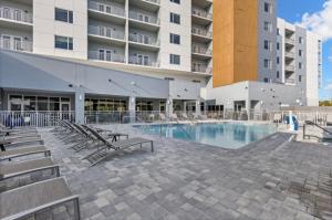 a swimming pool in front of a building at TownePlace Suites by Marriott Cape Canaveral Cocoa Beach in Cape Canaveral