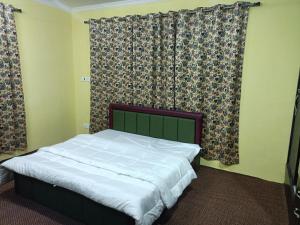 Cama en habitación con cortinas y cama sidx sidx sidx sidx sidx sidx sidx en Coachman HomeStay, en Srinagar