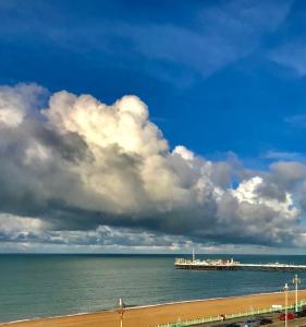a view of the beach with a pier in the water at BRIGHTON BEACH APARTMENT Parking Free & EV Port in Brighton & Hove