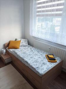a bed in a room with a window at Byt v centre mesta Snina in Snina
