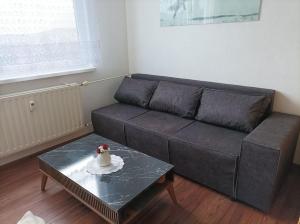 a living room with a couch and a table with a cake at Byt v centre mesta Snina in Snina