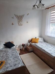 a bedroom with two beds and a window at Byt v centre mesta Snina in Snina