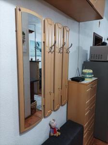 a teddy bear sitting on a stool in front of a mirror at Byt v centre mesta Snina in Snina