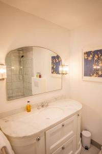 a white bathroom with a sink and a mirror at Greentrees Estate -The Oak Suite in Haywards Heath