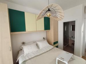 a bedroom with a bed with a umbrella above it at Casa Valsecca in Krk