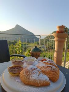 a plate of bread and pastries on a table at La Roccia Incantata Amalfi Coast in Vietri sul Mare