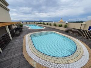 a swimming pool on top of a building at Lovely Waterfront Riverbank Suite with Pool A2 in Kuching