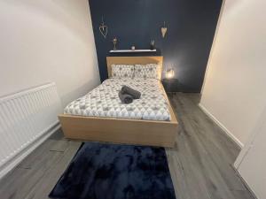 a bedroom with a bed with a wooden floor at Joyous Private Room in City Centre in Liverpool