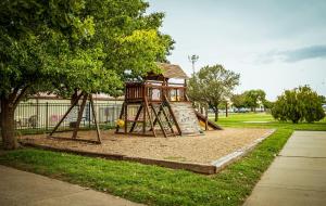a playground with a slide in a park at Big Texan Wagons in Amarillo