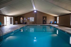 a swimming pool with blue water in a building at Big Texan Wagons in Amarillo