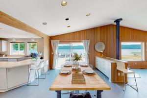 a kitchen with a wooden table and a large window at The Blue Ox in Hoodsport