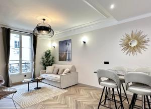 a living room with a couch and a table at Charming Apartment with Eiffel Tower View in Paris