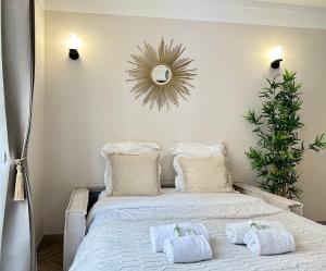 a bedroom with a bed with towels on it at Charming Apartment with Eiffel Tower View in Paris