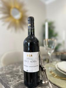 a bottle of wine sitting on top of a table at Charming Apartment with Eiffel Tower View in Paris