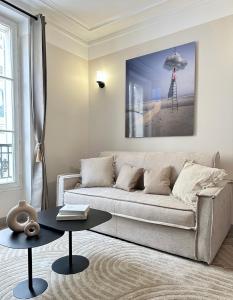 a living room with a couch and a table at Charming Apartment with Eiffel Tower View in Paris +33 photos
