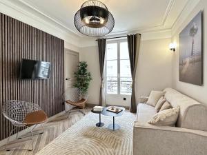 a living room with a couch and a table at Charming Apartment with Eiffel Tower View in Paris