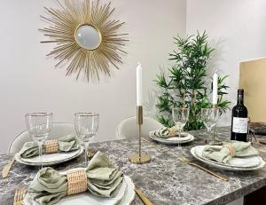 a dining room table with a table set with wine glasses at Charming Apartment with Eiffel Tower View in Paris