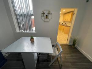 a white table in a room with a kitchen at Boutique Accommodation in Central Location in Liverpool