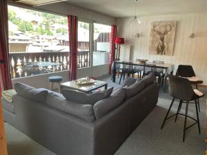 ein Wohnzimmer mit einem Sofa und einem Tisch in der Unterkunft Appartement Les Gets, 3 pièces, 8 personnes - FR-1-623-72 in Les Gets