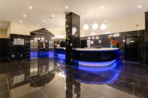 a lobby with a blue bar in a building at Olissippo Marques de Sa in Lisbon