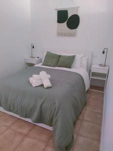 a bedroom with a bed with two towels on it at San Centro Wizink IFEMA Metropolitano Airport Apartments in Madrid